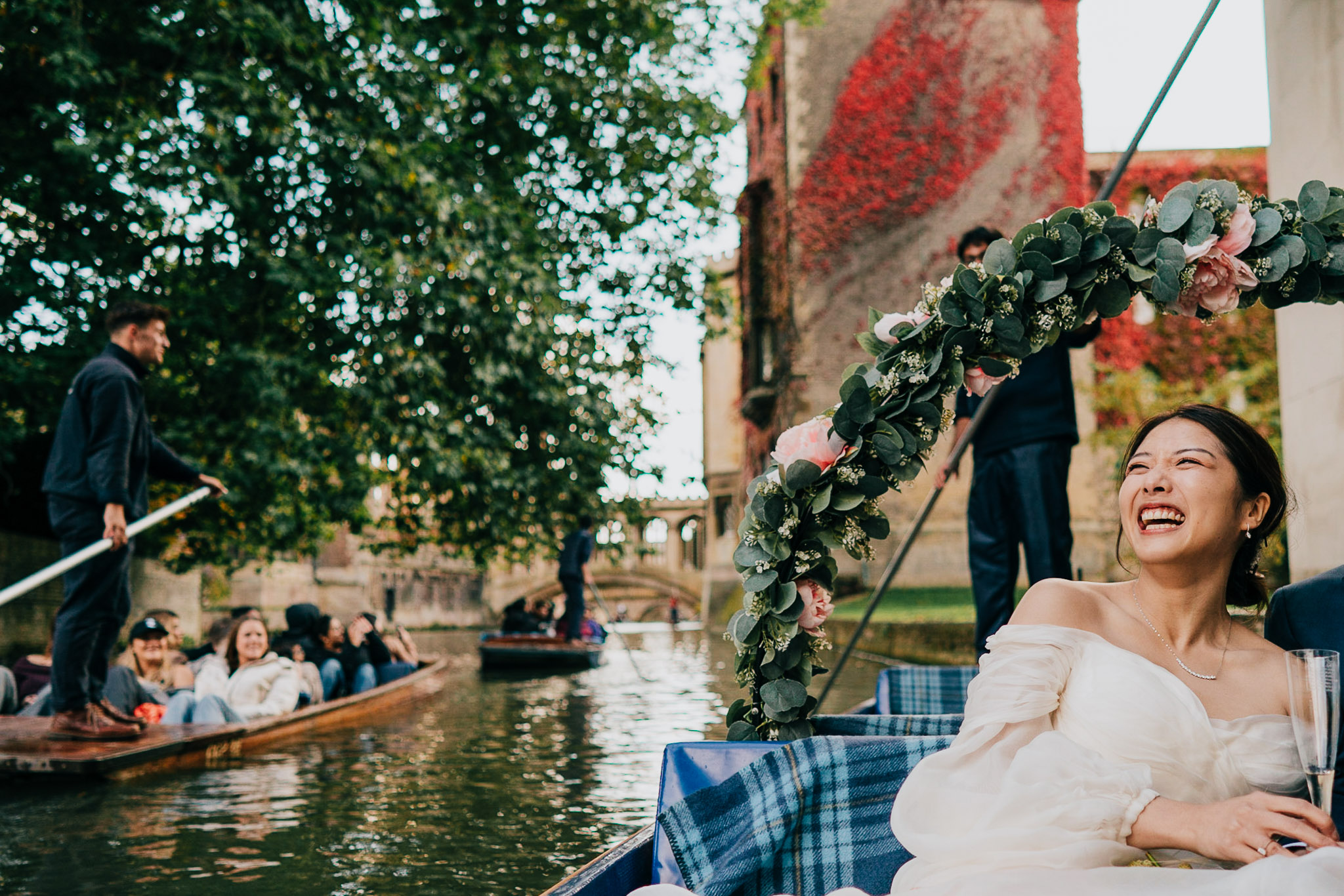 Audrey laughing whilst punting down the river Cam, shortly after getting married.