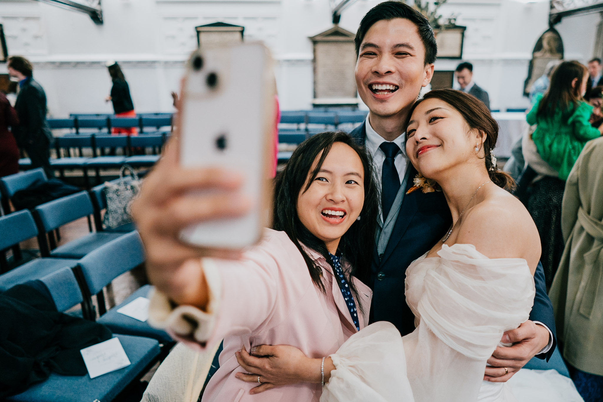A friend taking a selfie with the couple after their St Andrew the Great ceremony