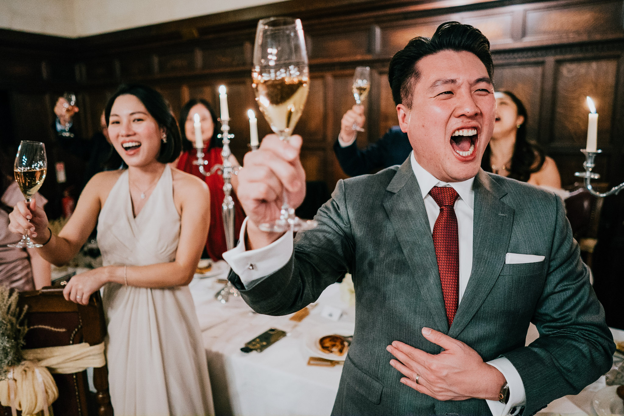 Guests mid-way through the Yam Seng wedding toast, at Westminster College, Cambridge