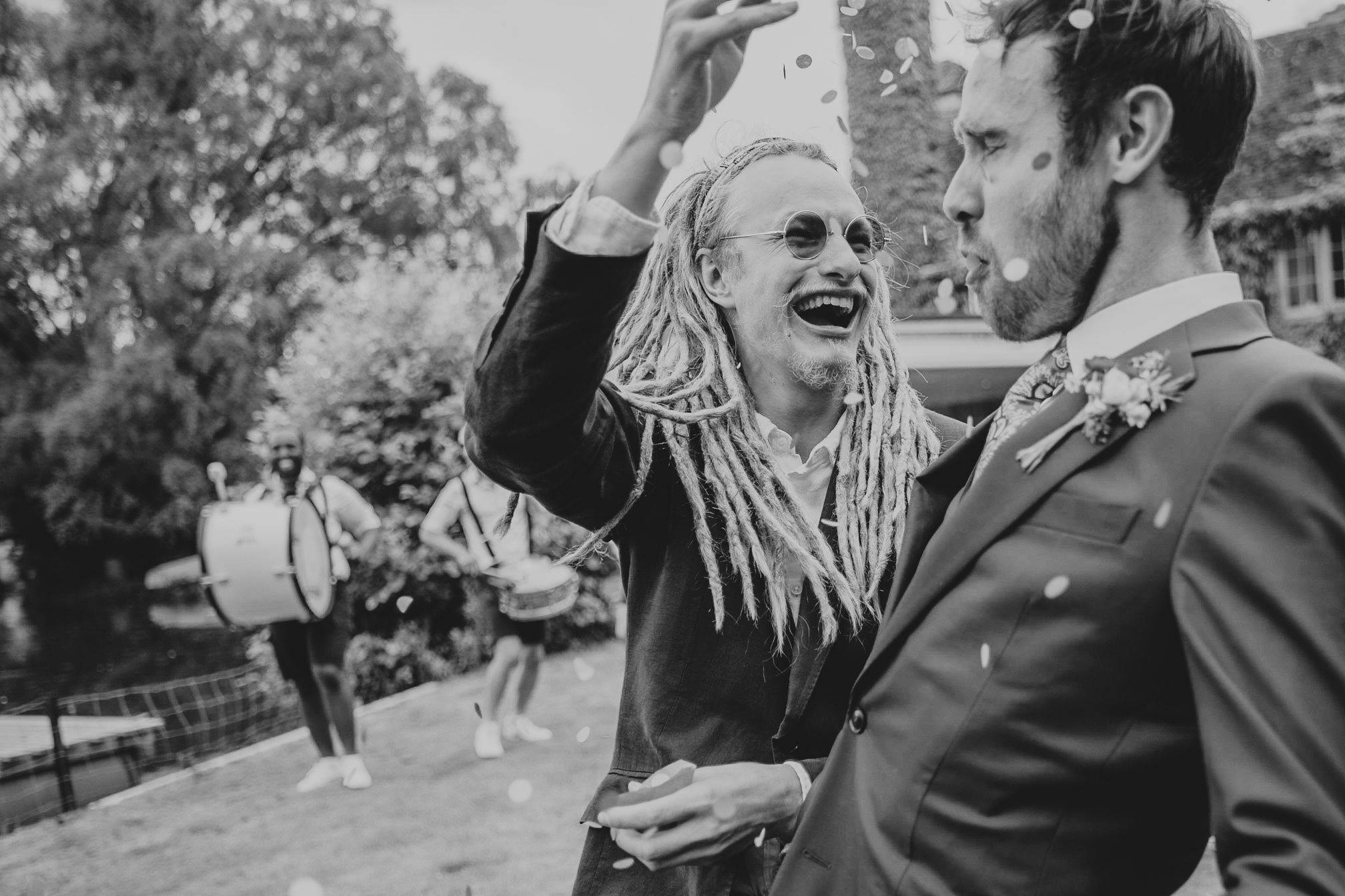 baldock-wedding-photographer 4 – Alan Law Photography A wedding guest throws confetti over Danny, the groom.