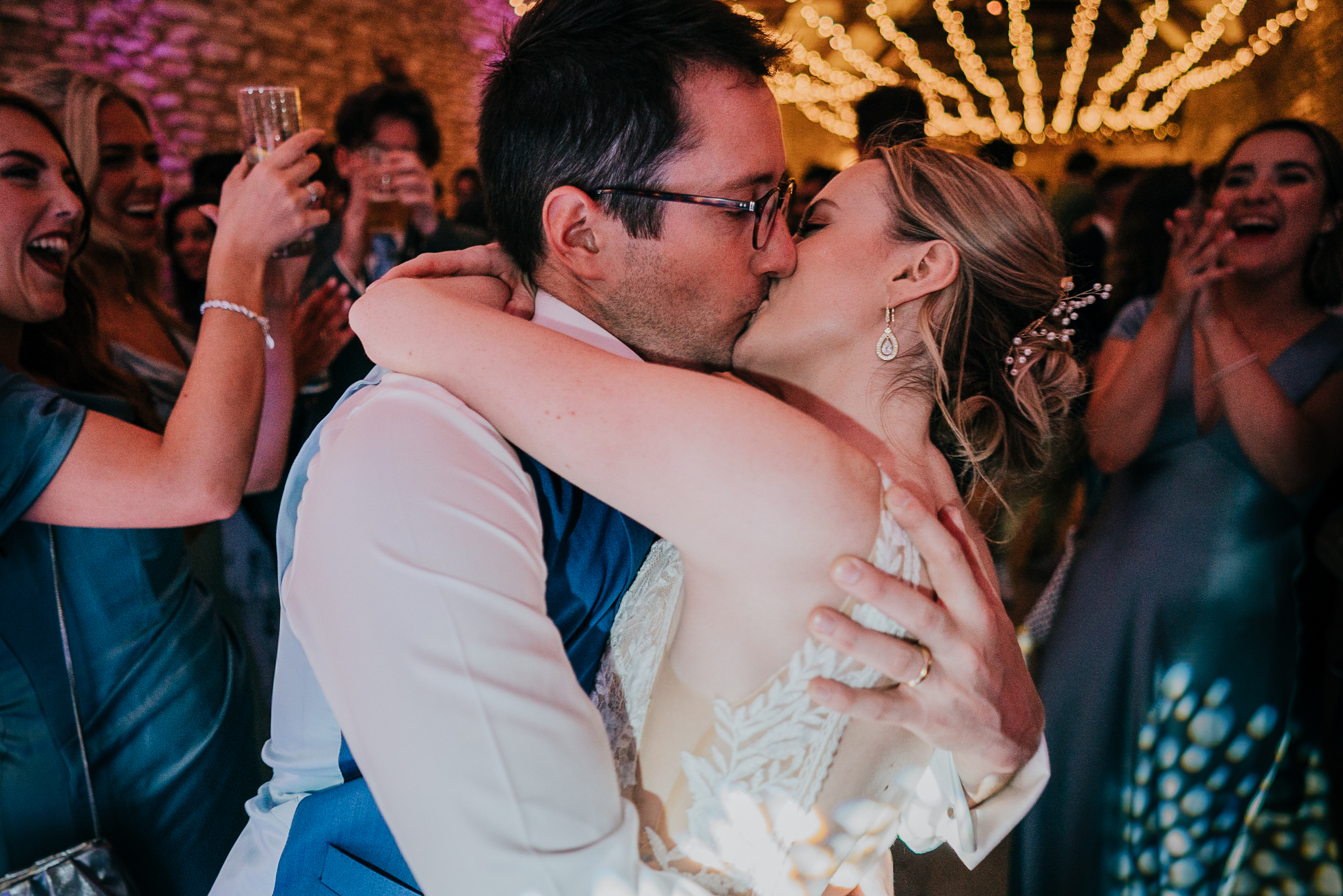 The bride and groom kiss on the dancefloor at Caswell House.