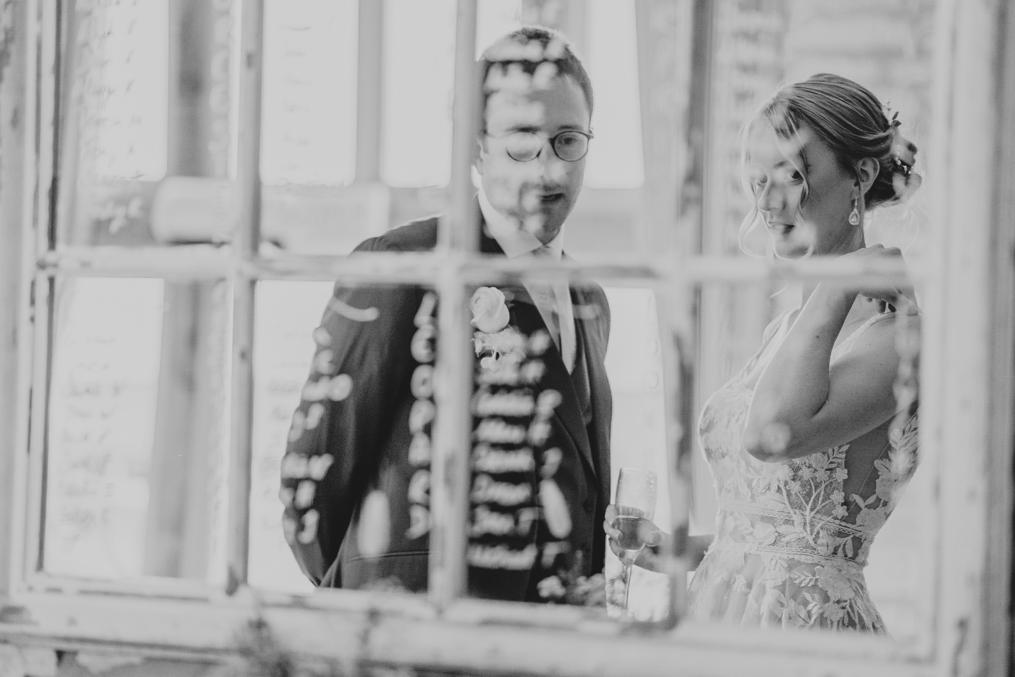 The bride and groom reflected in their seating plan at Caswell House.