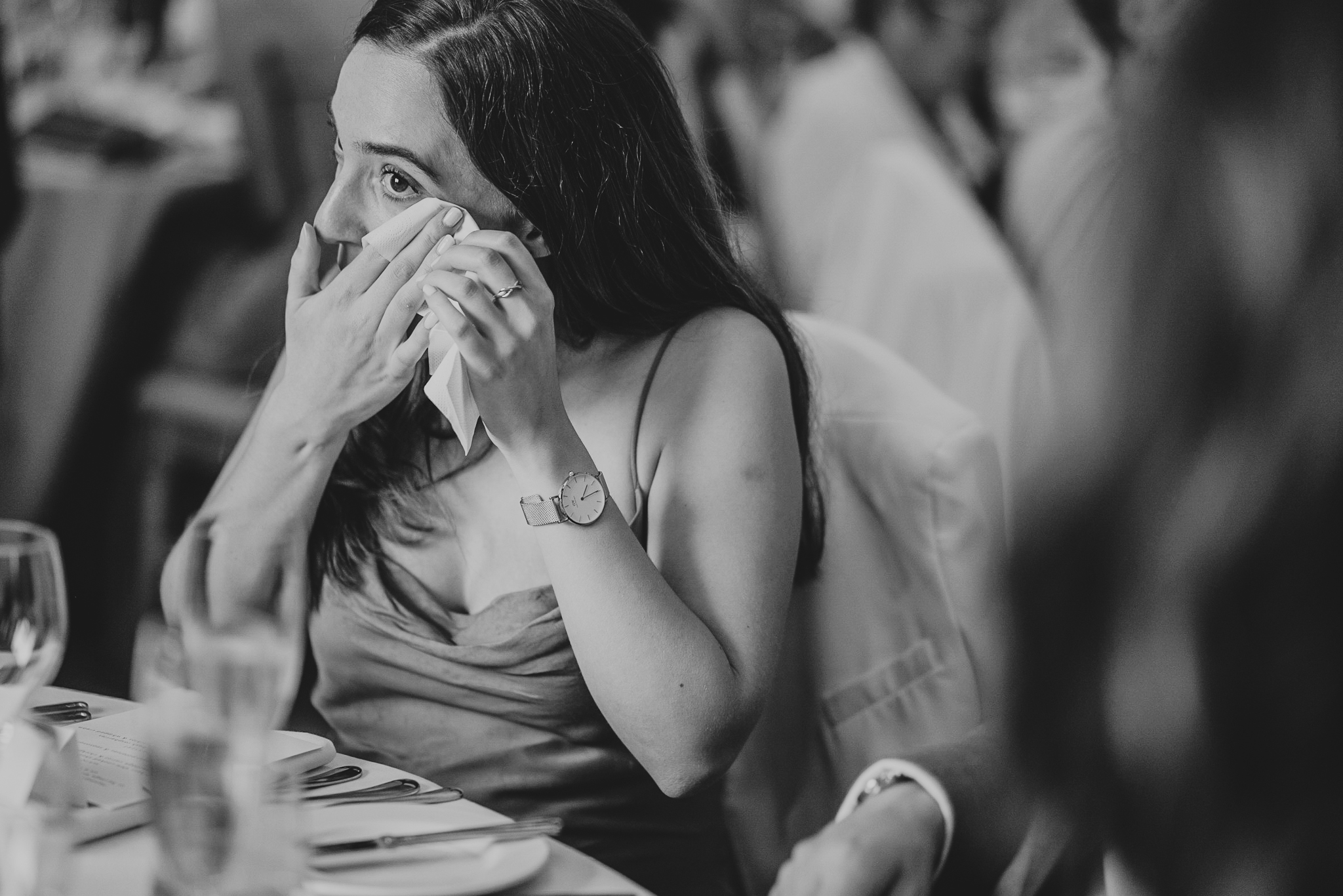 A guest wipes away a tear during speeches at Caswell House.