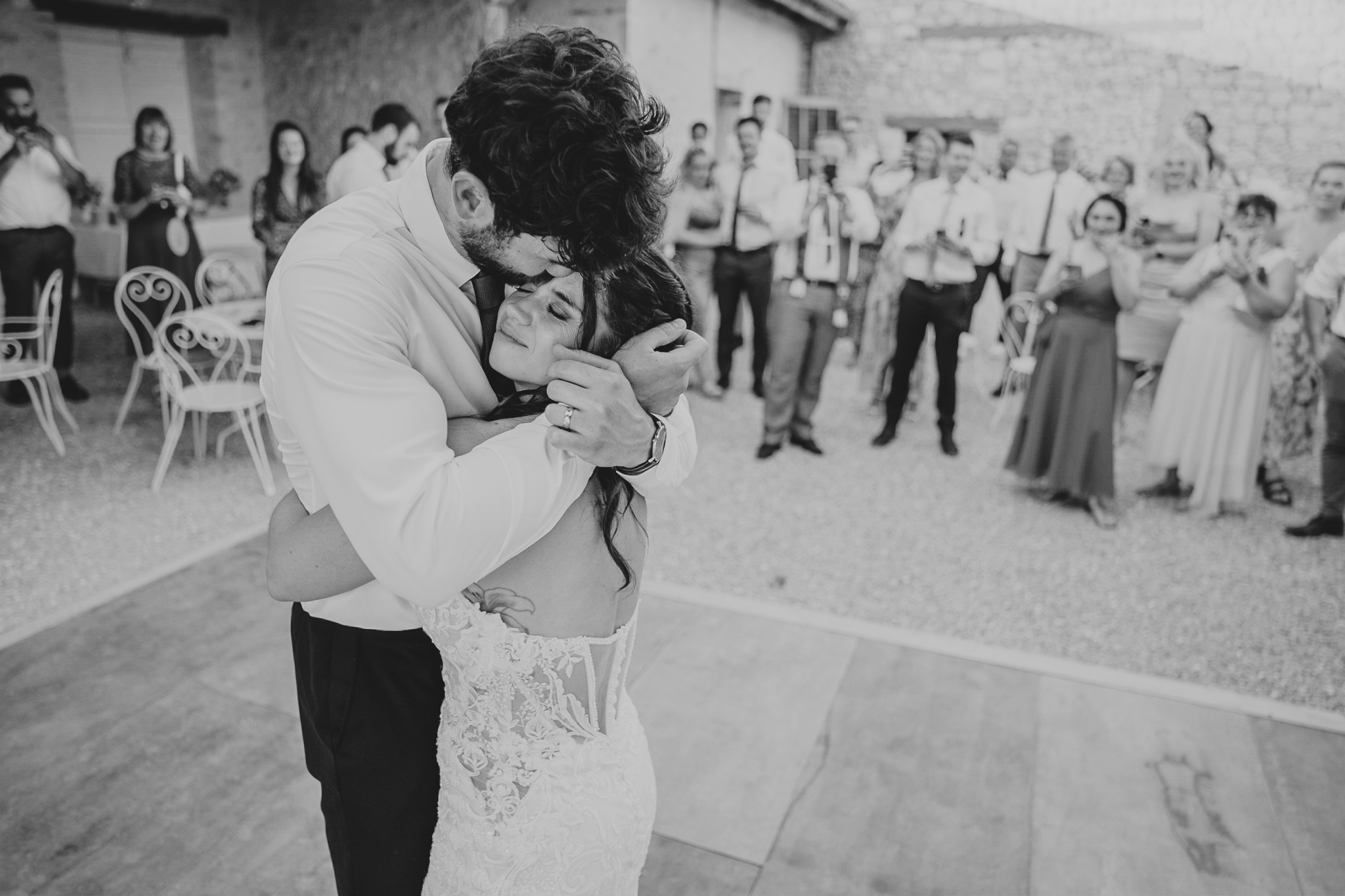 chateau-de-st-paul-wedding-photographer 3 – Alan Law Photography Joe kisses Aurelie on the head during their outdoor First Dance at Château de St Paul.