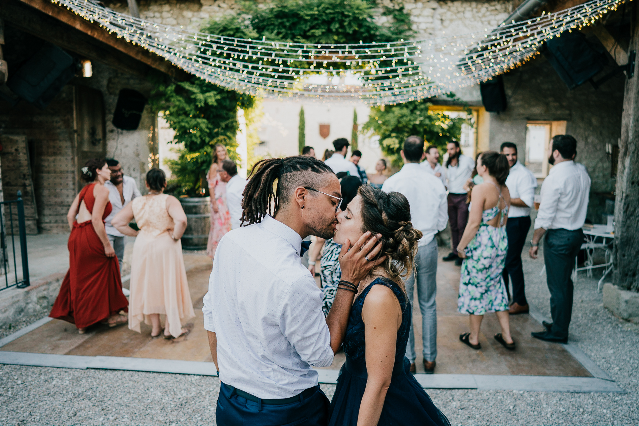 chateau-de-st-paul-wedding-photographer 5 – Alan Law Photography Two wedding guests share an embrace in the evening at Château de St Paul.