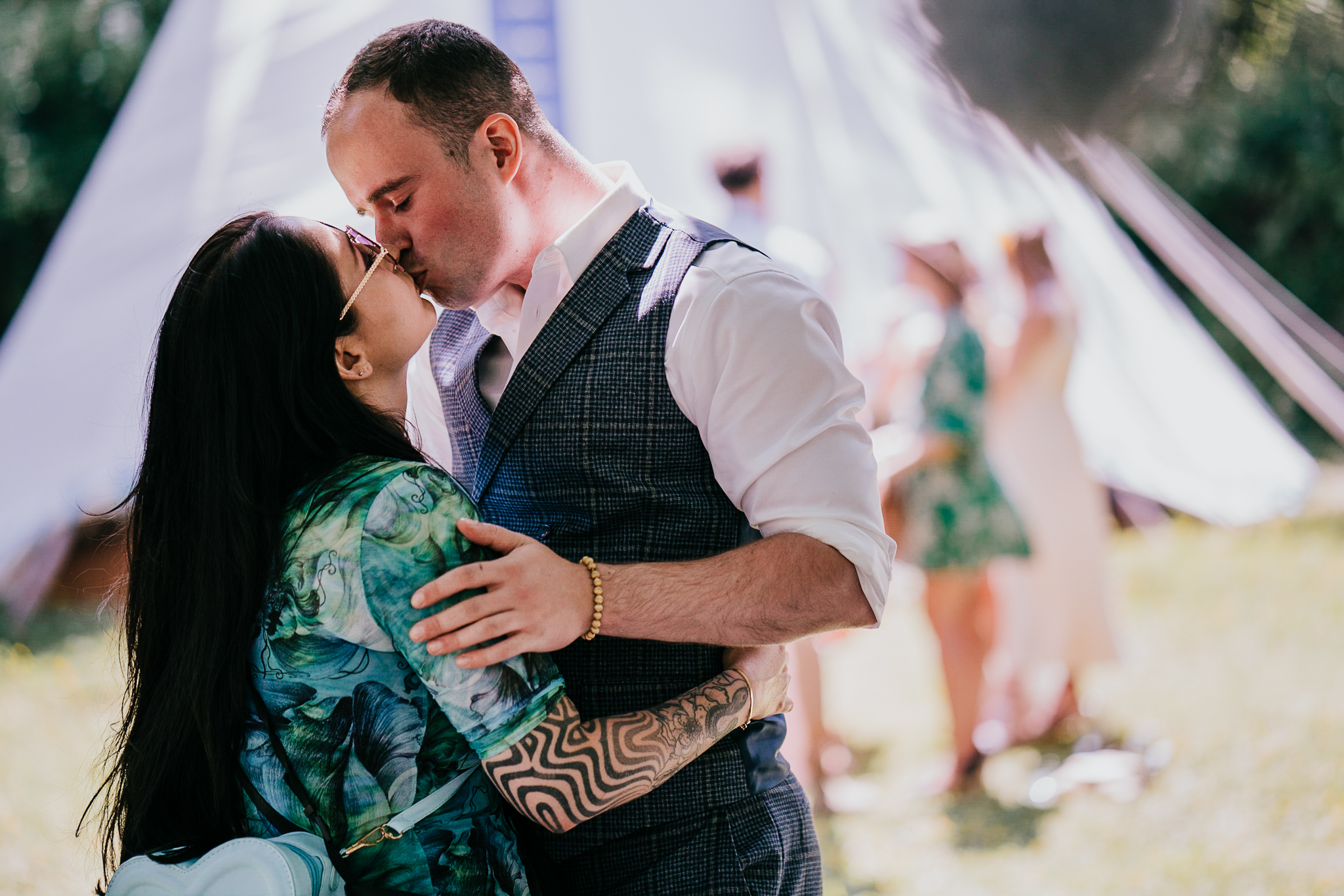 cornish-tipi-weddings-photographer 5 – Alan Law Photography Two guests kiss during the cocktail hour at Cornish Tipi Weddings