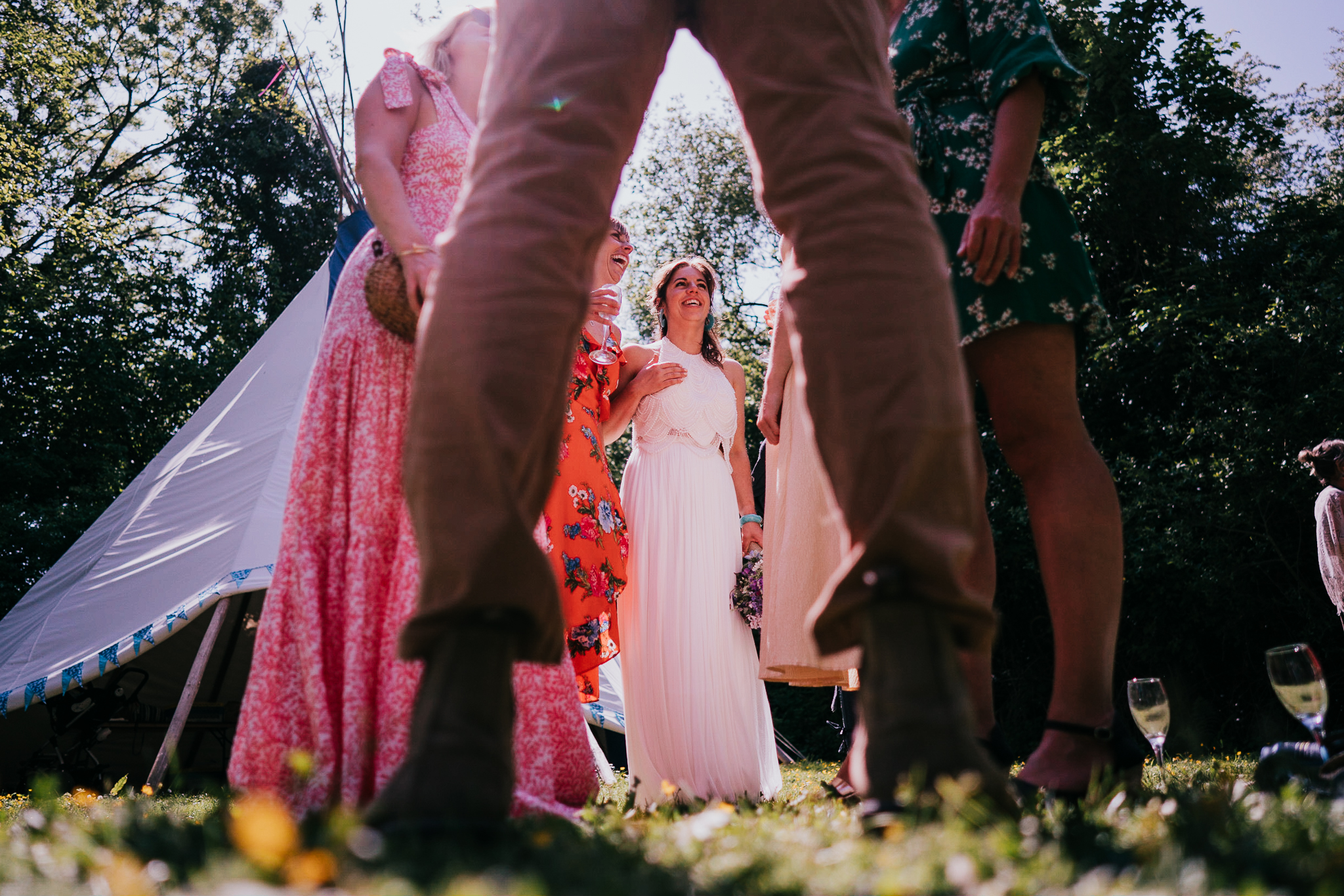 cornish-tipi-weddings-photographer 6 – Alan Law Photography The bride chats to her guests at Cornish Tipi Weddings, shot from ground level.