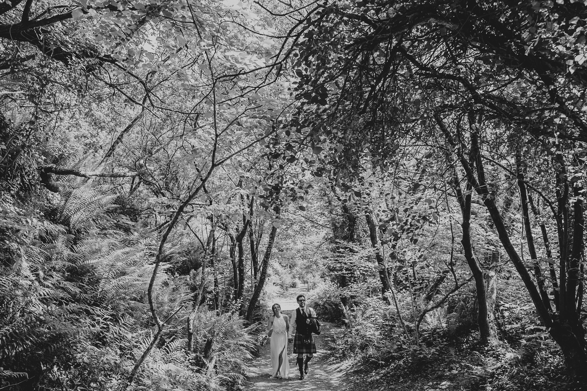 cornish-tipi-weddings-photographer 7 – Alan Law Photography The bride and groom stroll through the woodland at Cornish Tipi Weddings