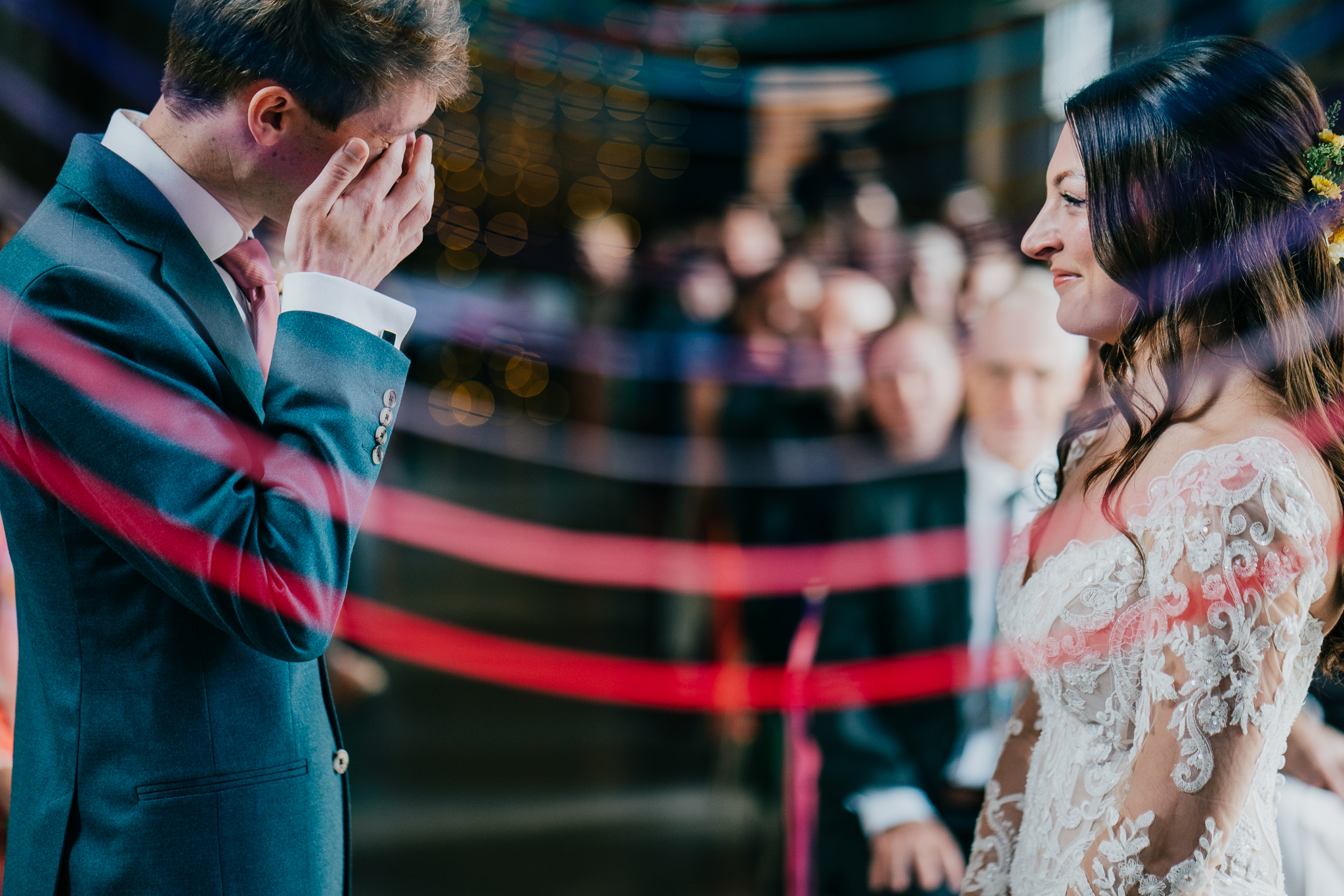 henham-park-wedding-photographer 4 – Alan Law Photography During their Henham Park wedding ceremony, the groom wipes his eyes, whilst his new bride looks on and smiles.