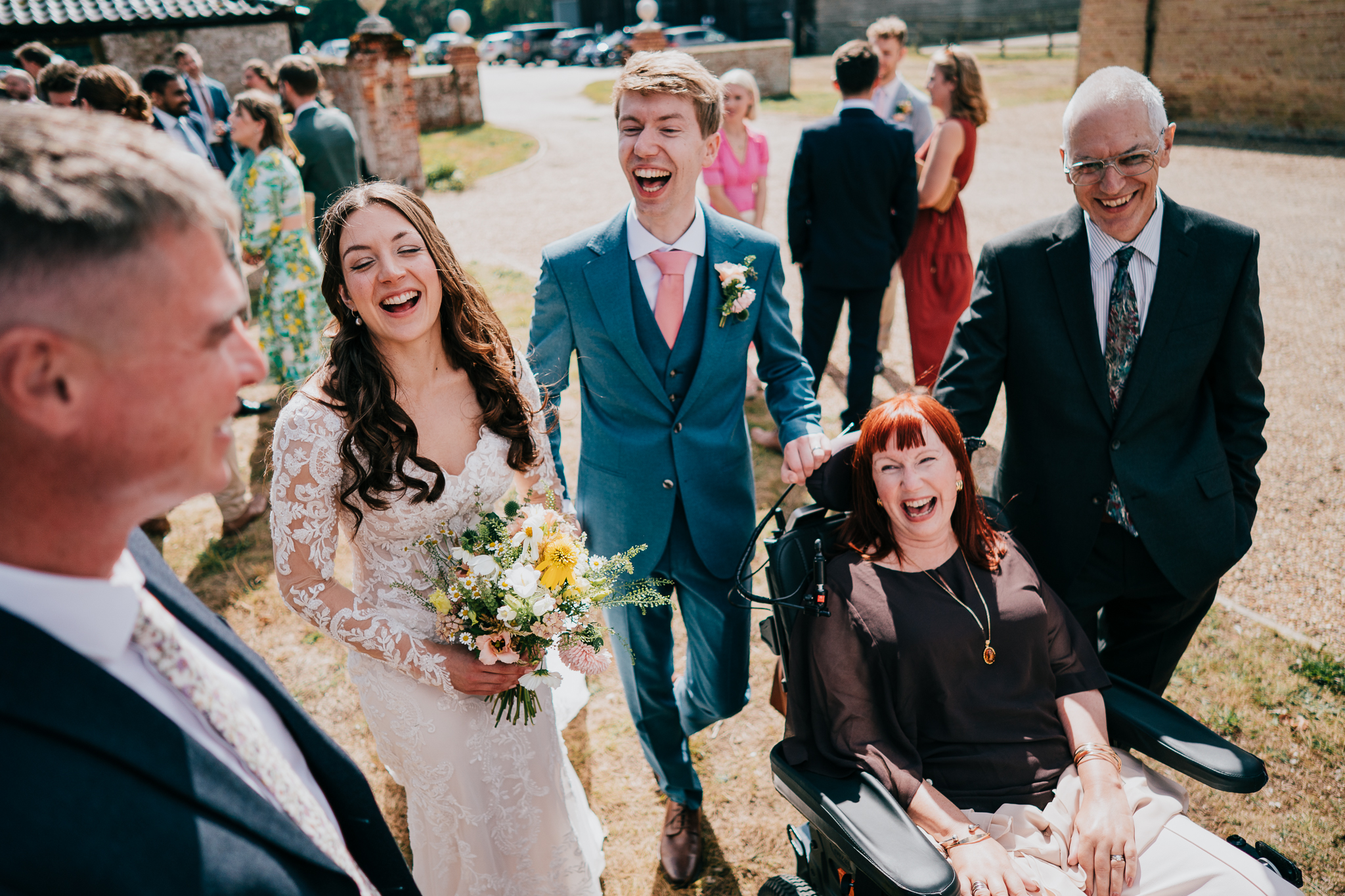 henham-park-wedding-photographer 7 – Alan Law Photography The bride and groom laughing with friends and family at Henham Park.