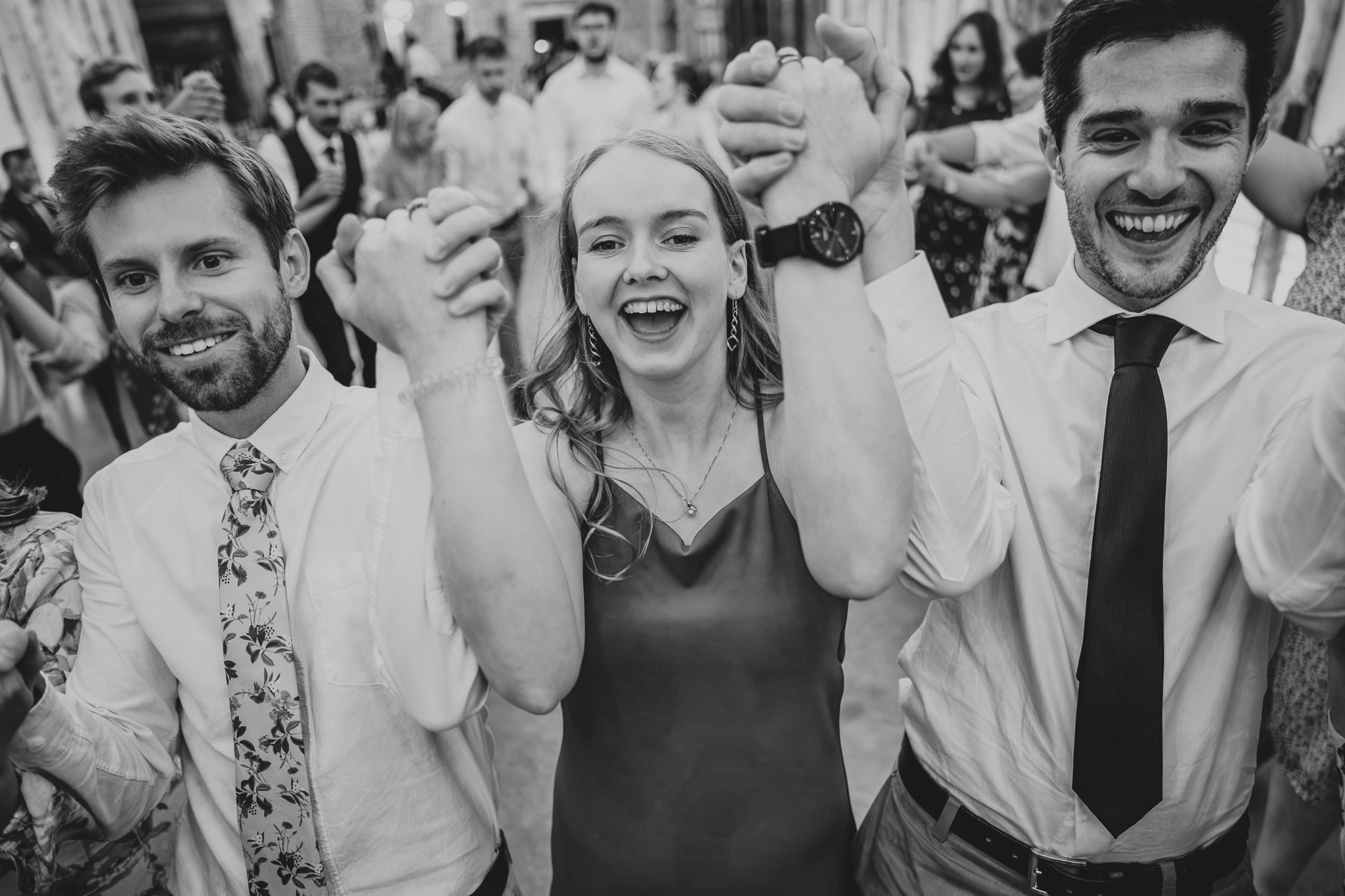 henham-park-wedding-photographer 9 – Alan Law Photography Guests link arms during a ceilidh at Henham Park