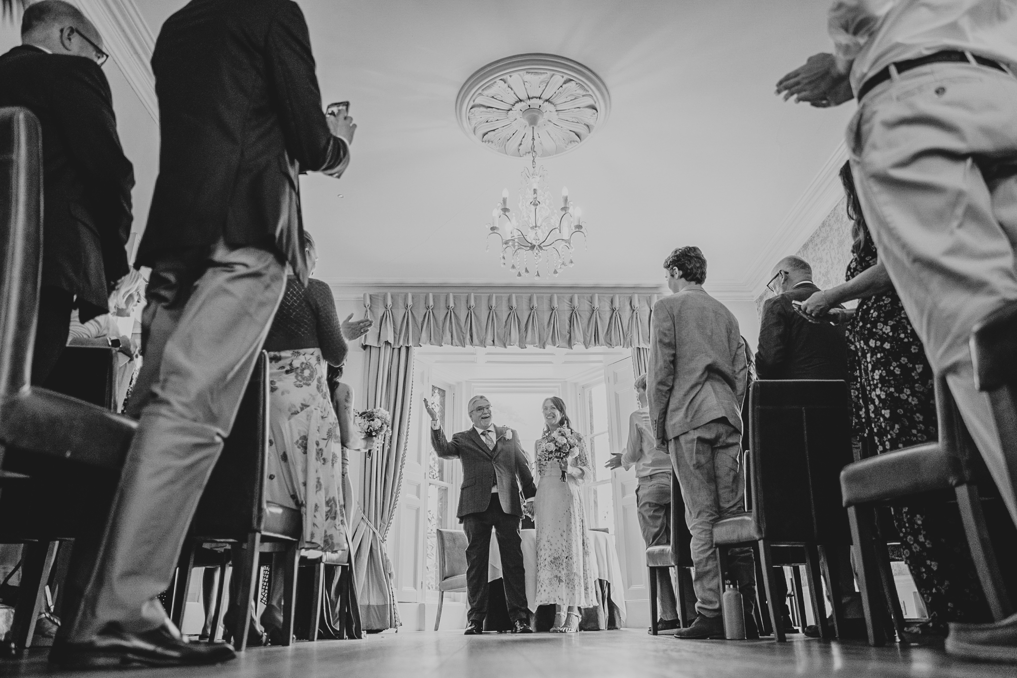 Low viewpoint of the bride and groom celebrating just getting married at The Horn of Plenty.