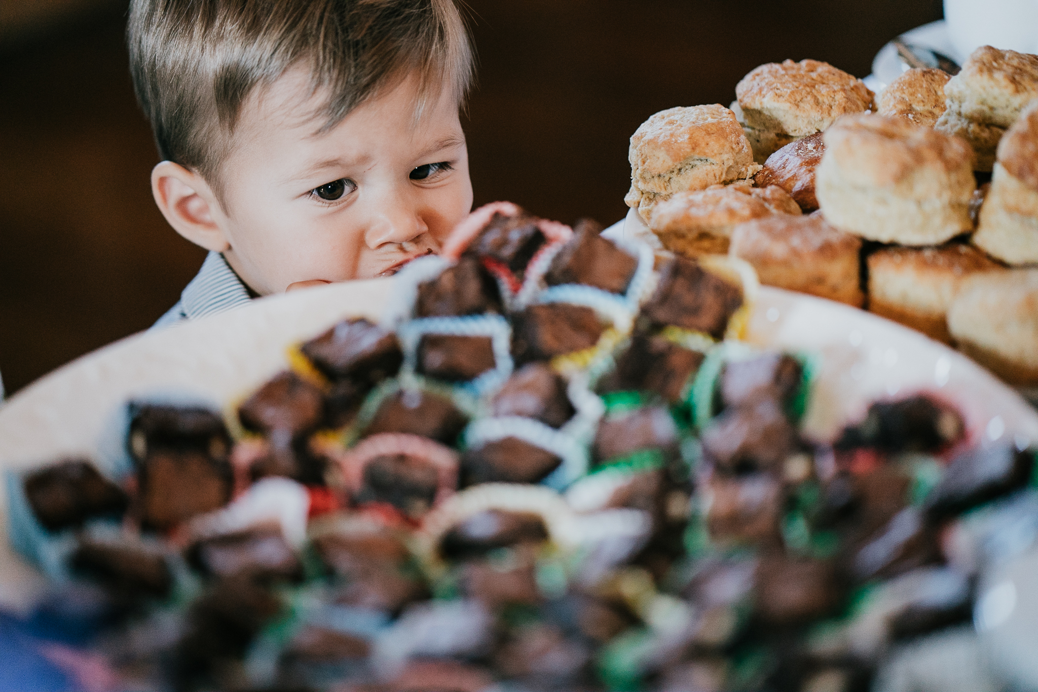 lynton-town-hall-wedding-photographer 3 – Alan Law Photography A young guest eyes up the cakes at Lynton Town Hall, Devon.