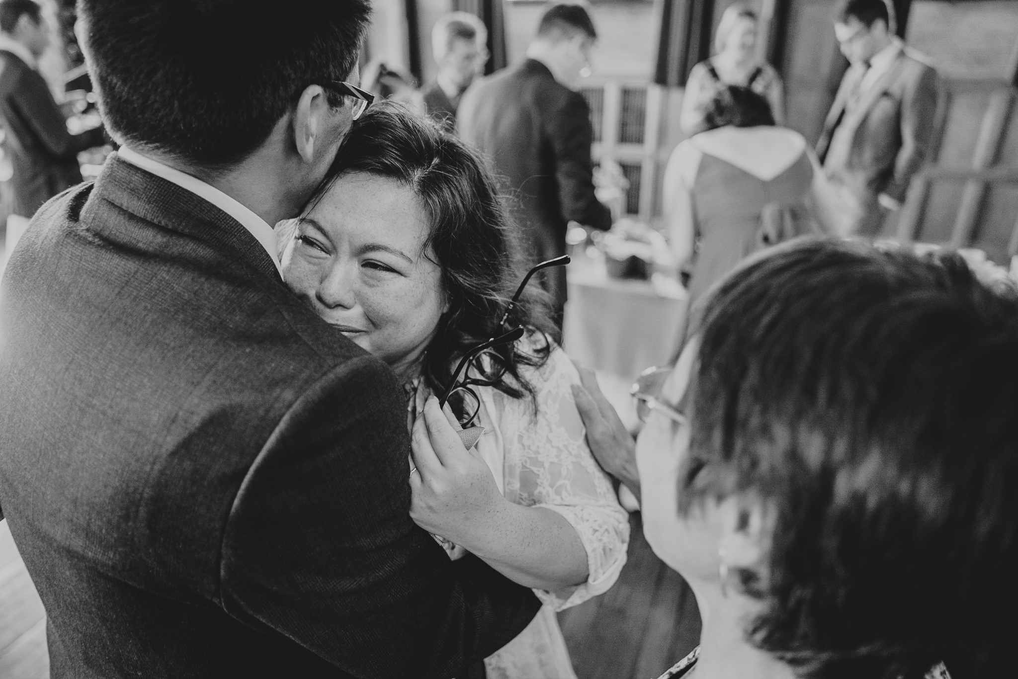 lynton-town-hall-wedding-photographer 4 – Alan Law Photography The groom's sister embraces the groom, visibly emotional after the wedding ceremony at Lynton Town Hall.