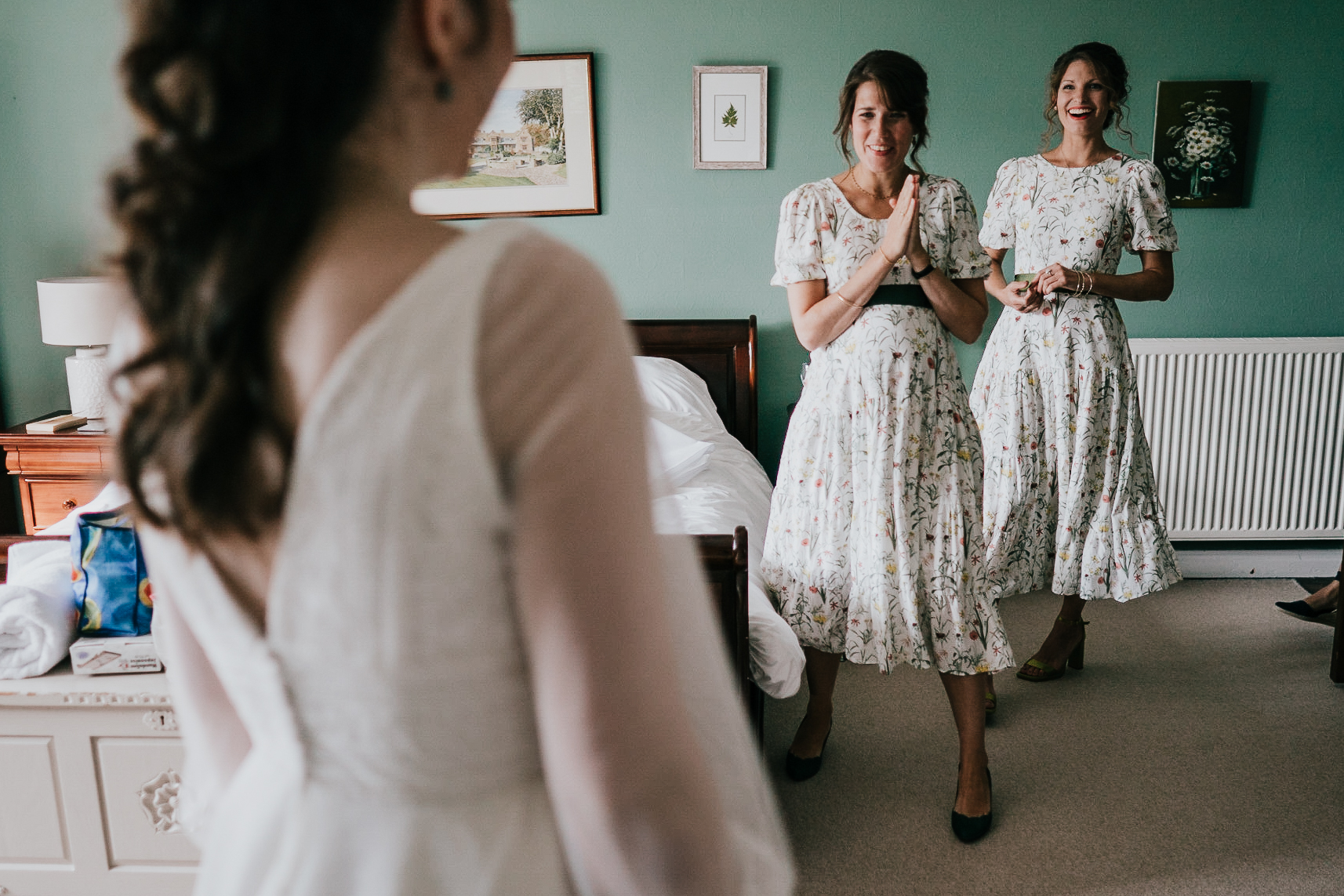 lynton-town-hall-wedding-photographer 8 – Alan Law Photography Penny's bridesmaids react to seeing her in her wedding dress for the first time.