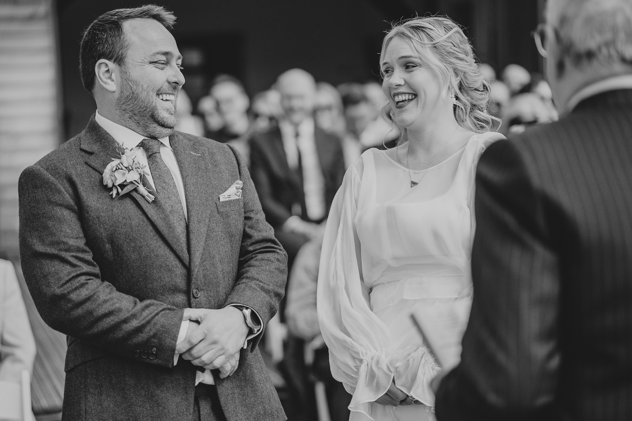 north-cadbury-court-wedding-photographer 4 – Alan Law Photography India and Paul exchanging a big laugh during their ceremony at North Cadbury Court in Somerset.