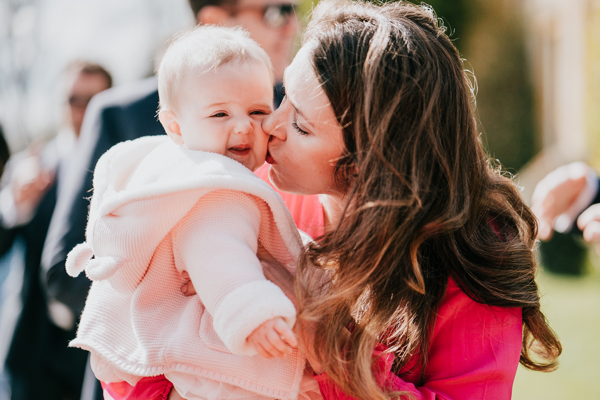 north-cadbury-court-wedding-photographer 5 – Alan Law Photography A wedding guests kisses her baby during the cocktail hour at North Cadbury Court.