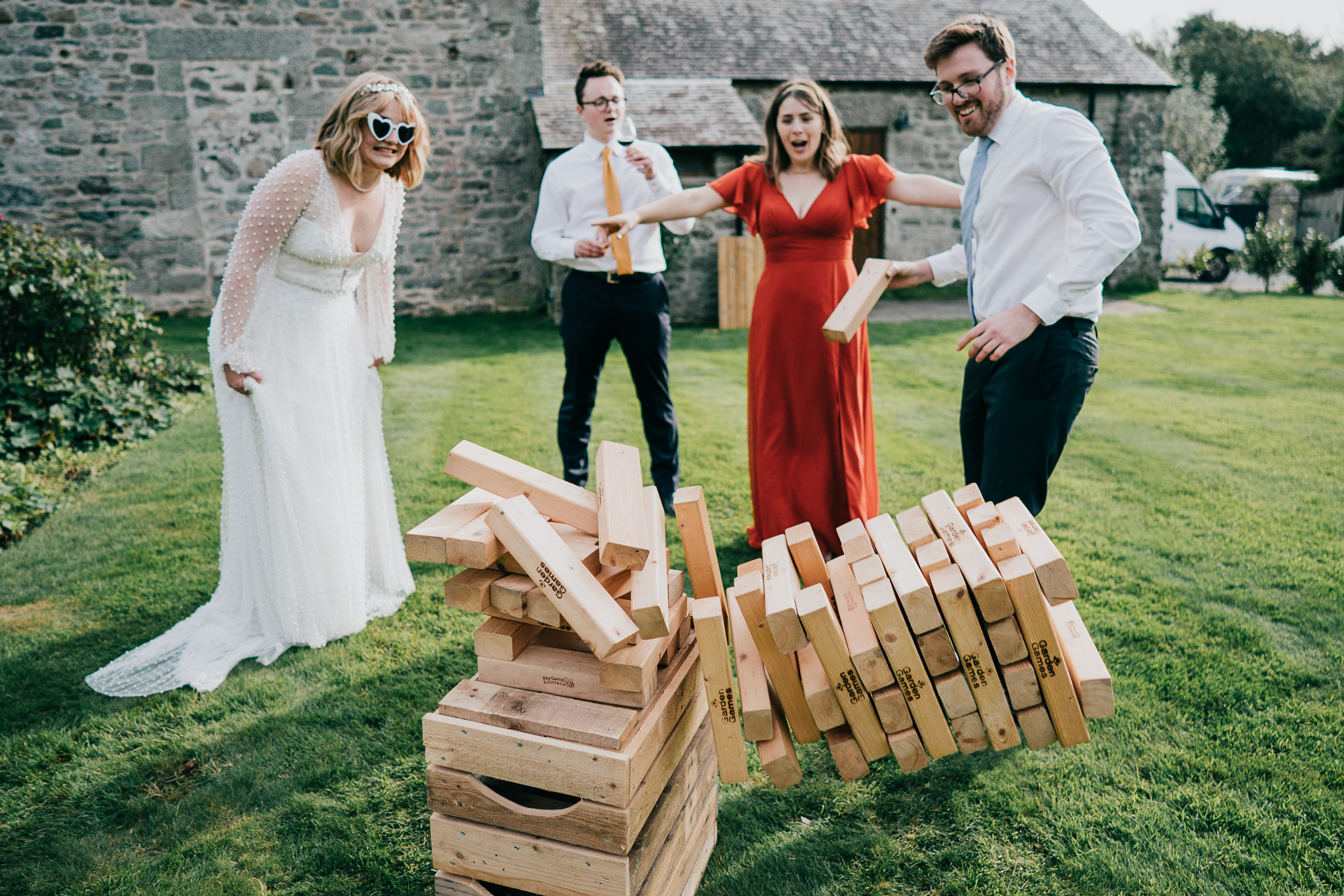pengersick-castle-wedding-photographer 2 – Alan Law Photography The bride and three guests play Giant Jenga in the grounds of Pengersick Castle, Cornwall.
