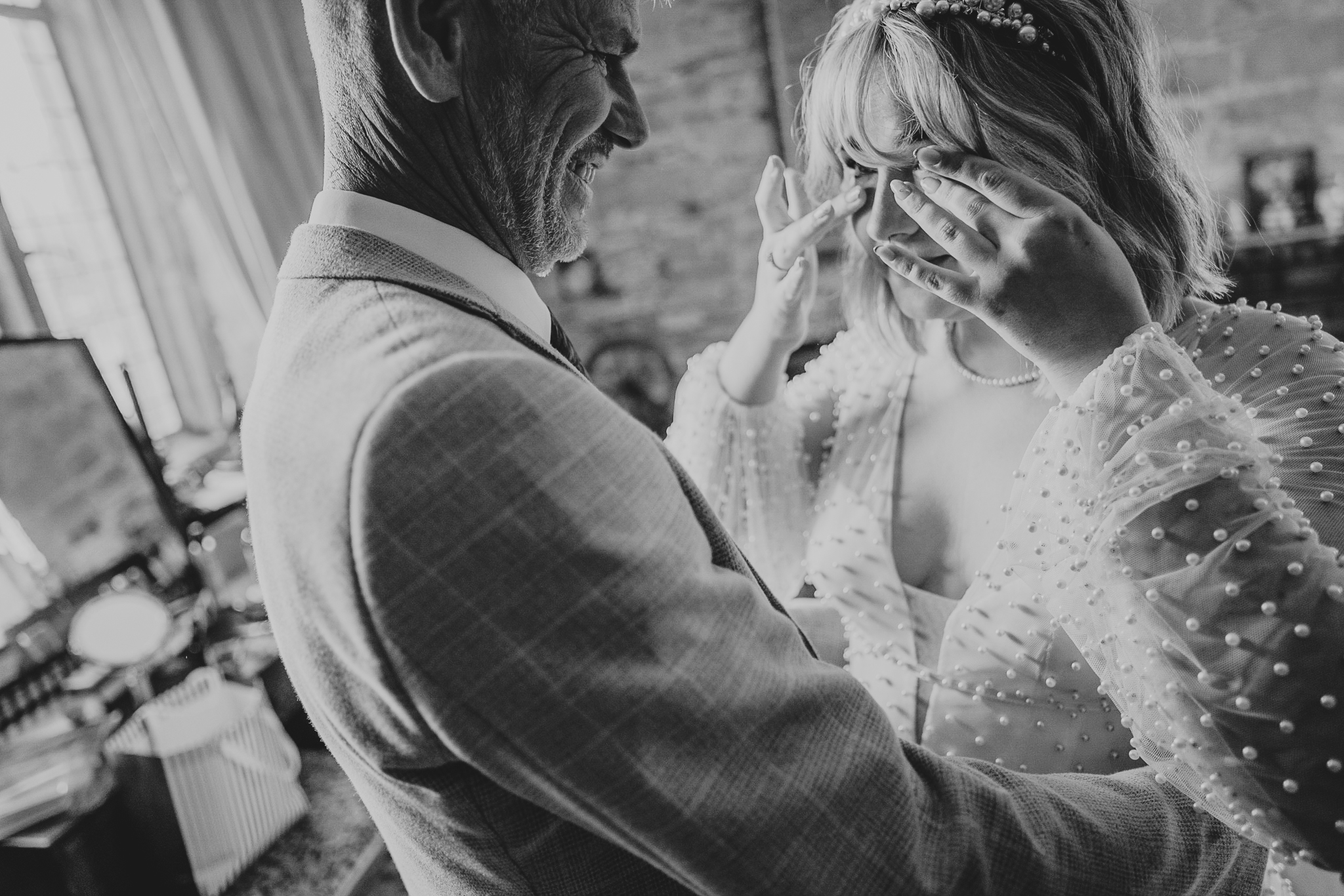 pengersick-castle-wedding-photographer 3 – Alan Law Photography The bride wipes tears from her eyes in Pengersick Castle as her Dad sees her in her dress for the first time.