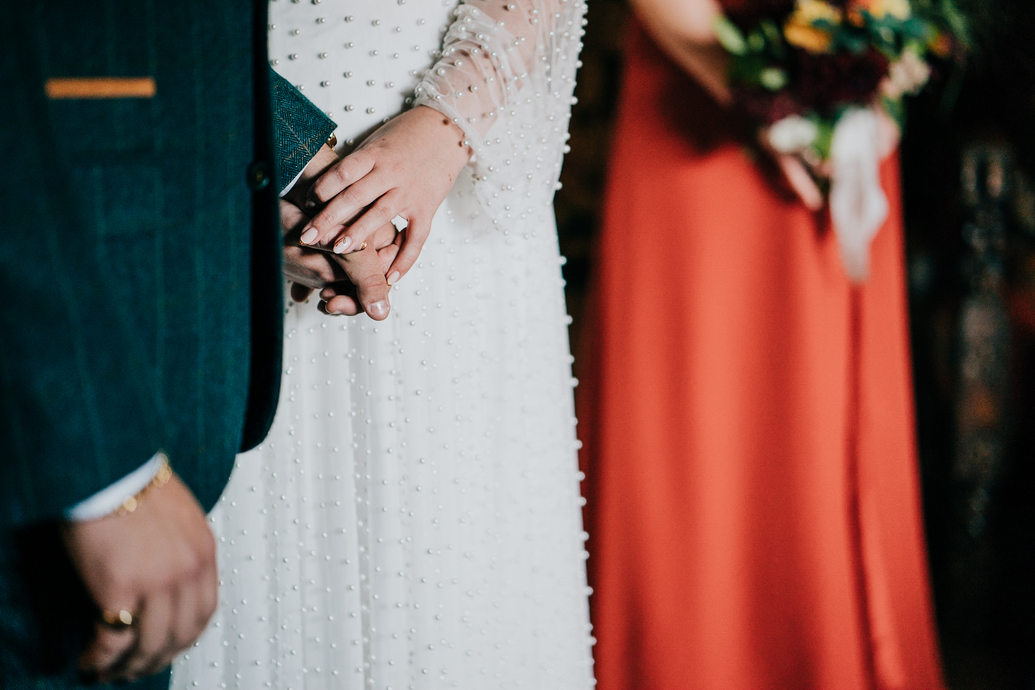 pengersick-castle-wedding-photographer 4 – Alan Law Photography A closeup of the couples' hands touching, during their wedding ceremony at Pengersick Castle