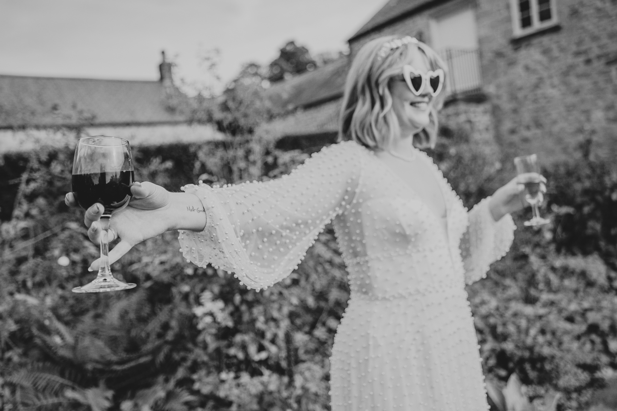 pengersick-castle-wedding-photographer 7 – Alan Law Photography The bride keeps a glass of wine at arms length, at Pengersick Castle.
