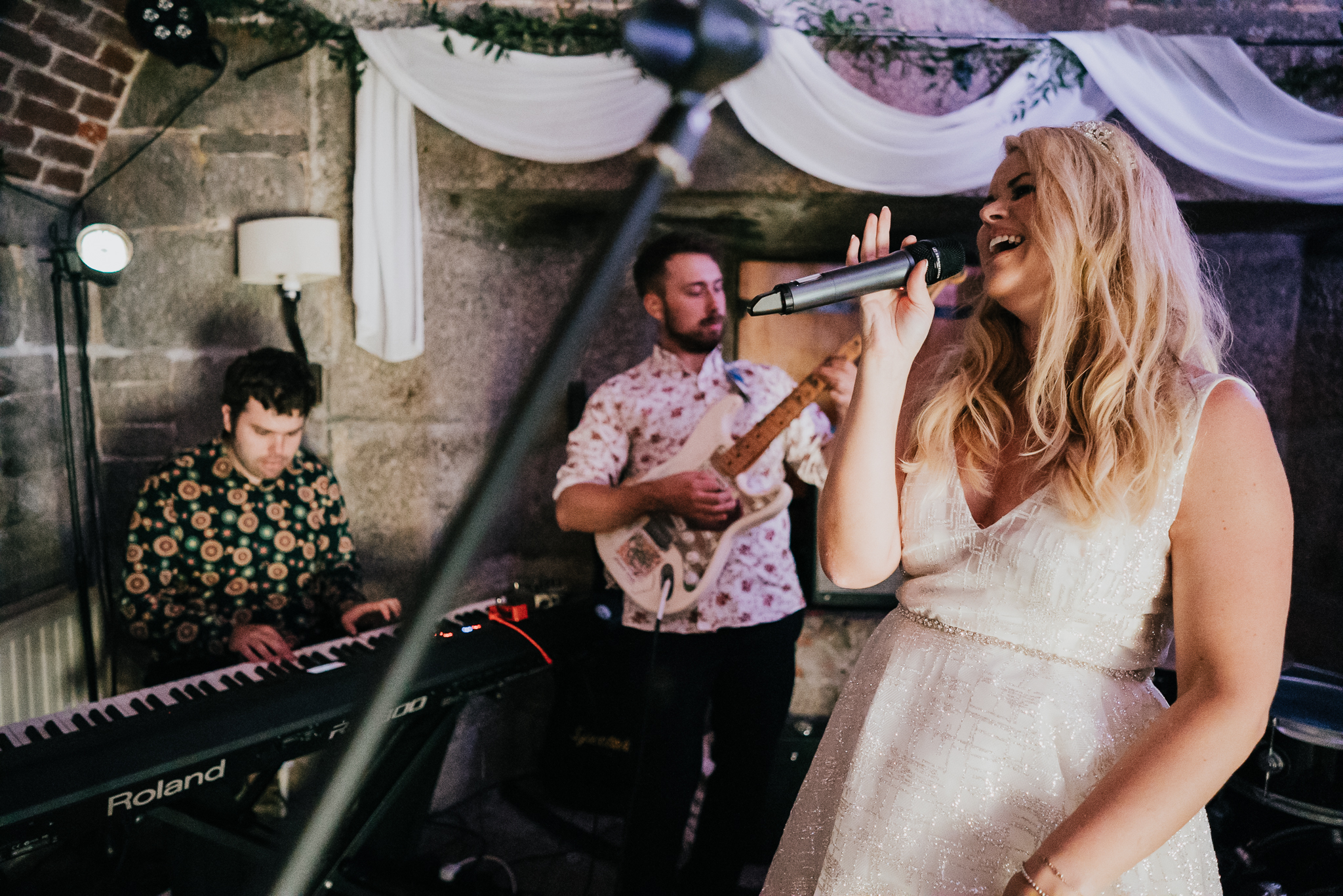 The bride singing her heart out with the band at Polhawn Fort