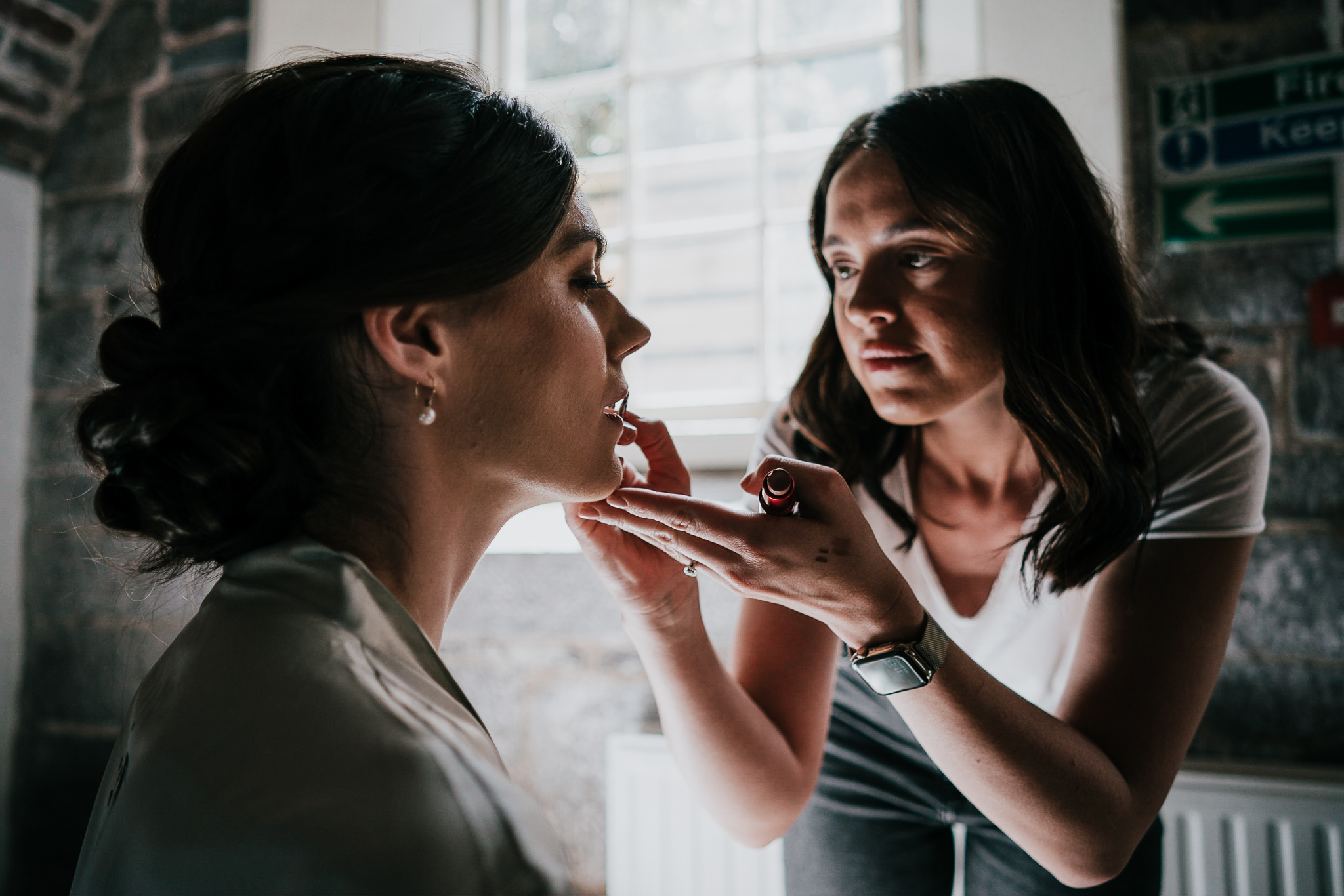 polhawn-fort-wedding-photography 2 – Alan Law Photography A bridesmaid receives lipstick from an MUA at Polhawn Fort.