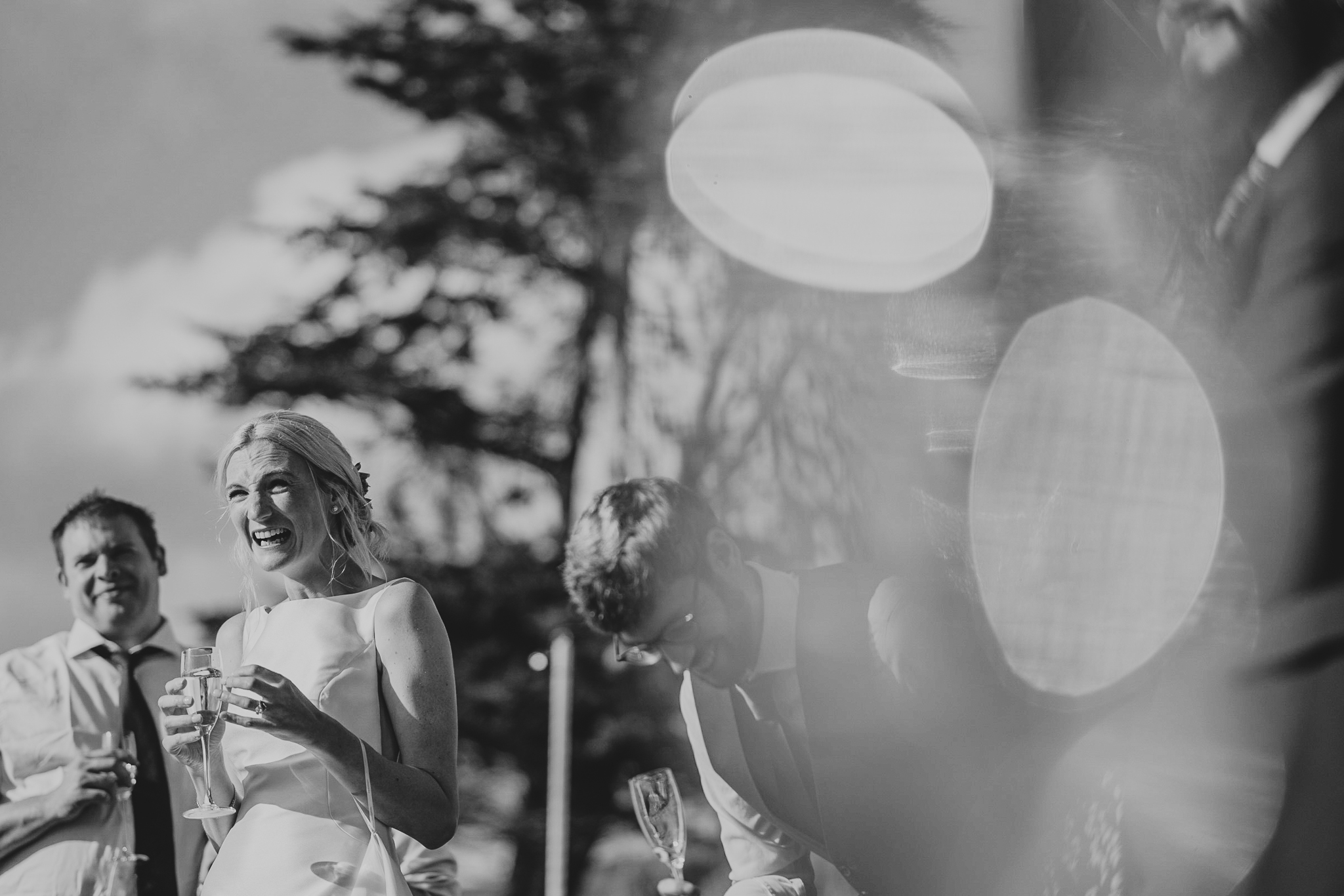 polhawn-fort-wedding-photography 8 – Alan Law Photography The bride laughs loudly during outdoor speeches at Polhawn Fort.