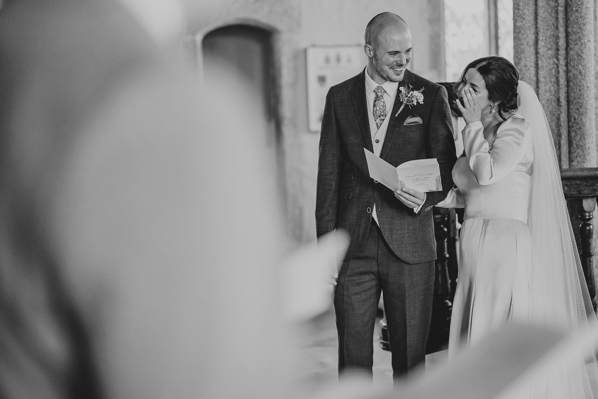 port-isaac-wedding-photographer 2 – Alan Law Photography At St Endellion Church, the bride and groom share a moment, with the bride wiping a tear.