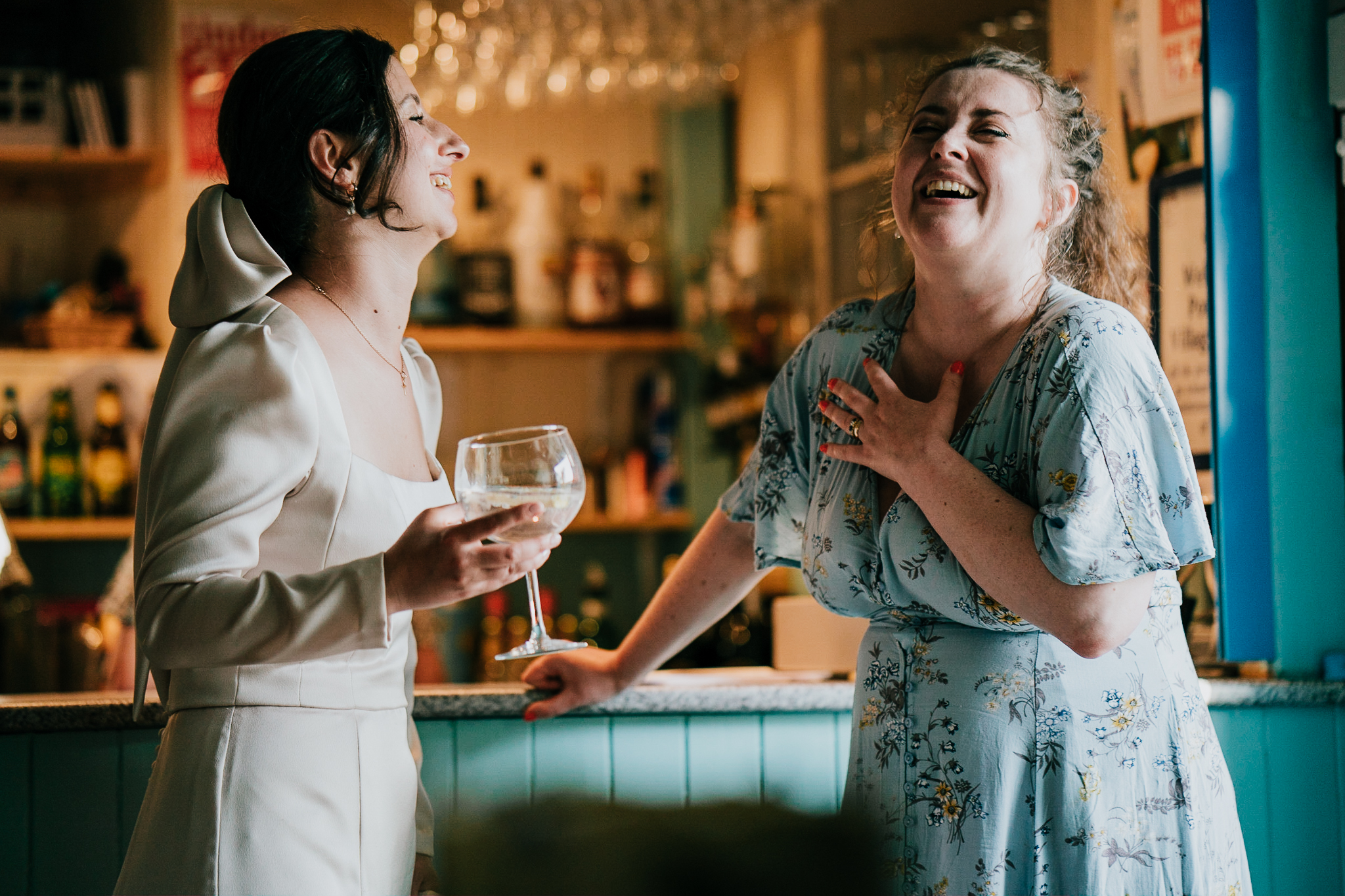 port-isaac-wedding-photographer 8 – Alan Law Photography The bride laughs with a guest at Port Isaac Village Hall.