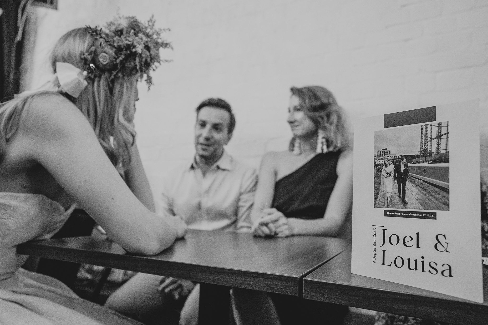 The bride chats to guests at The Hackney, with an engagement card/invite in the foreground.