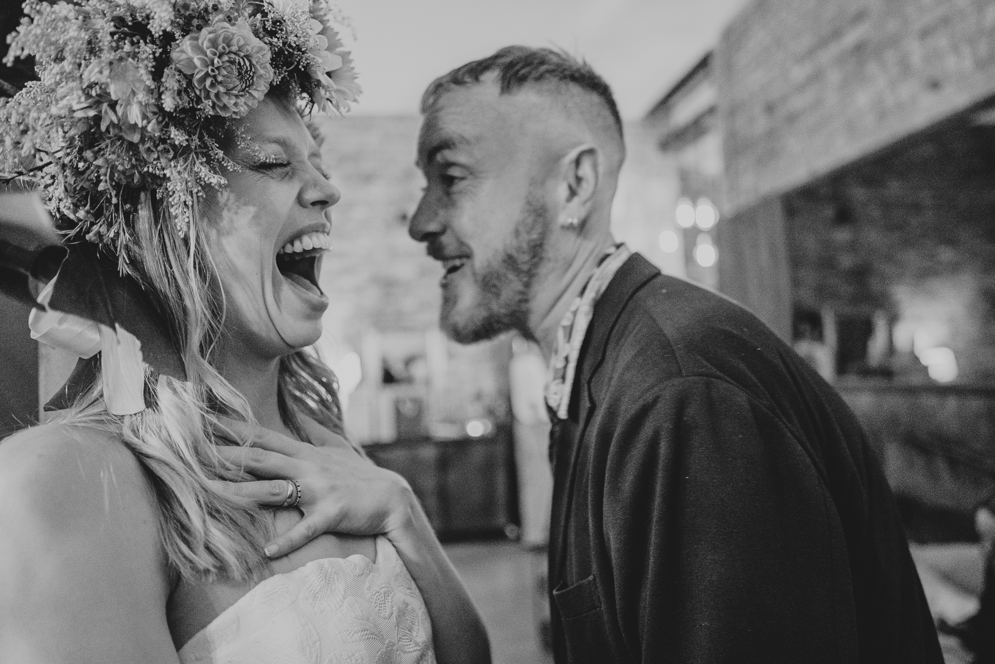 A huge laugh from the bride as she talks to a wedding guest at The Hackney